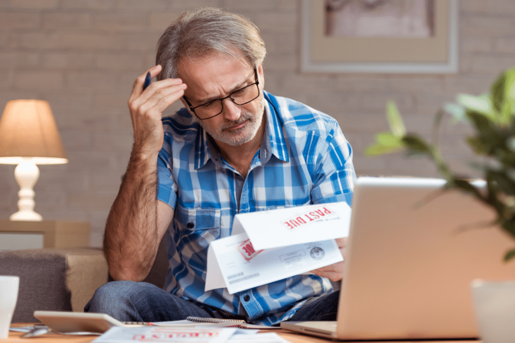 Man complexed looking at bankruptcy papers