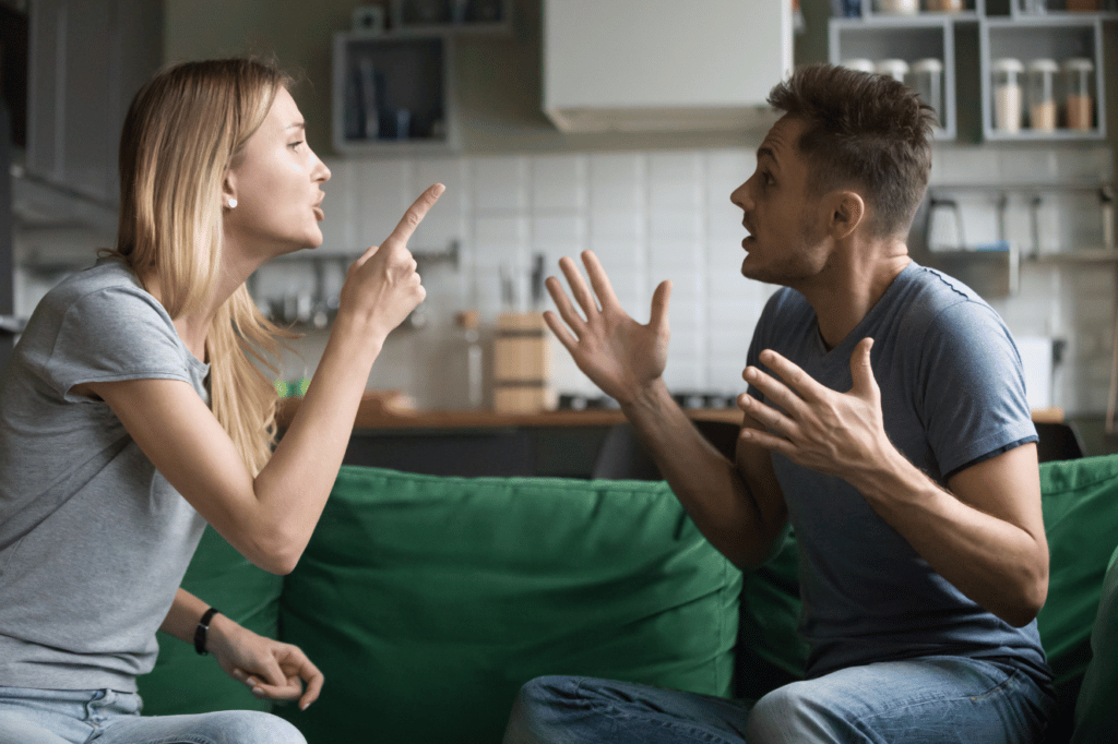 Married couple arguing on couch