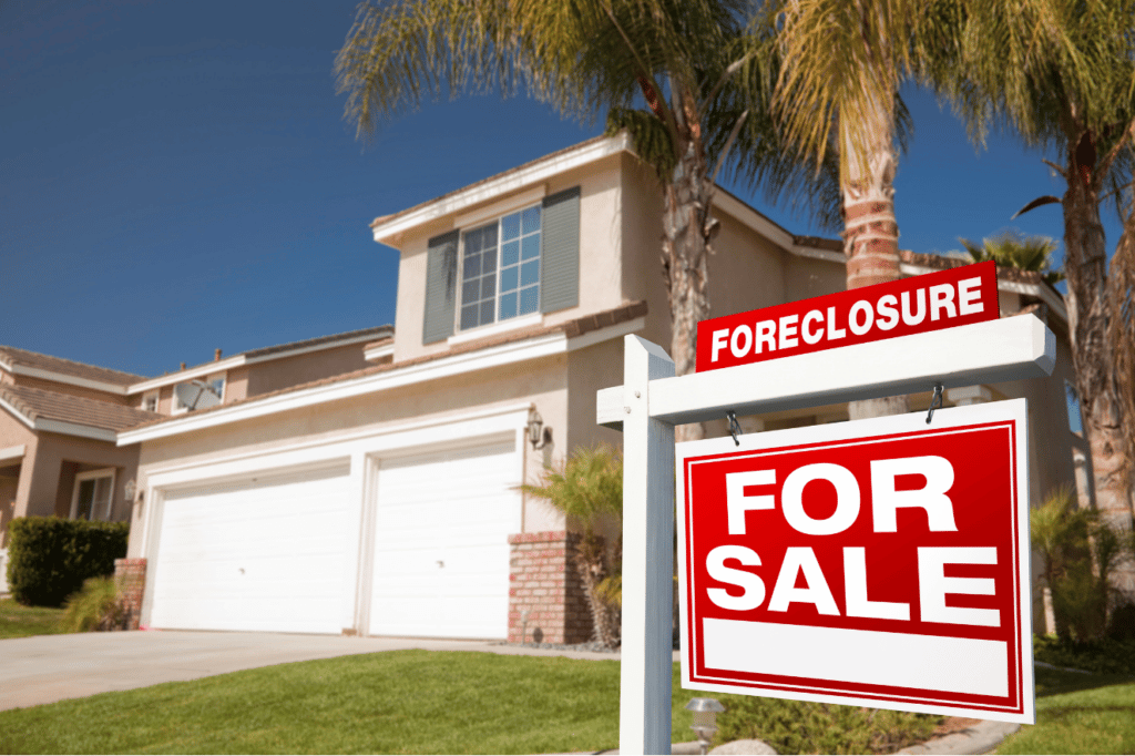 Home with foreclosure for sale sign