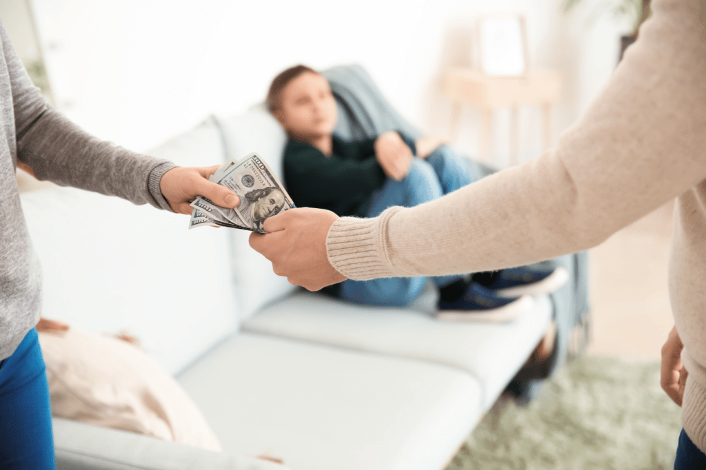 Parents giving each other money for child