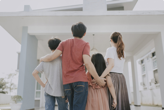 family in front of a house