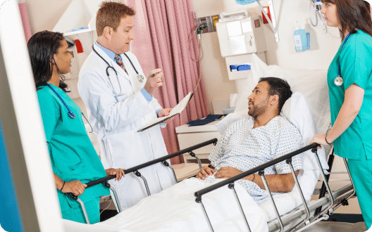 A doctor talking to a patient in a hospital bed