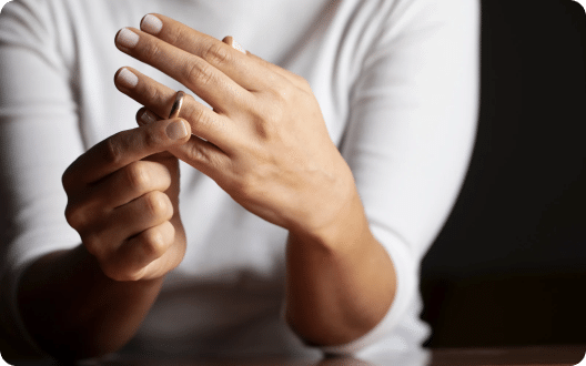 A person taking off their wedding ring