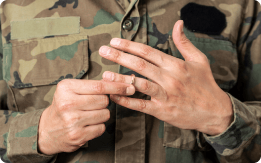 A military veteran taking off their wedding ring