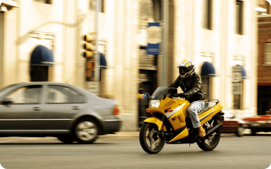 A person riding their motorcycle on the street