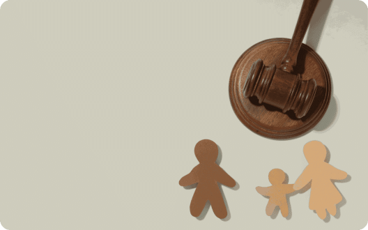A gavel next to a model of a family