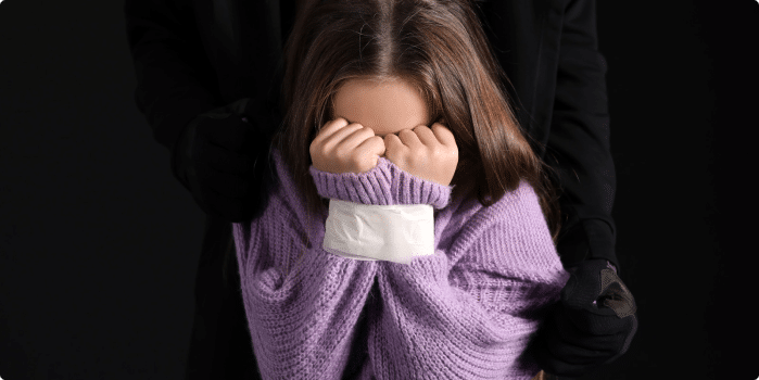 A little girl crying in front of her parent