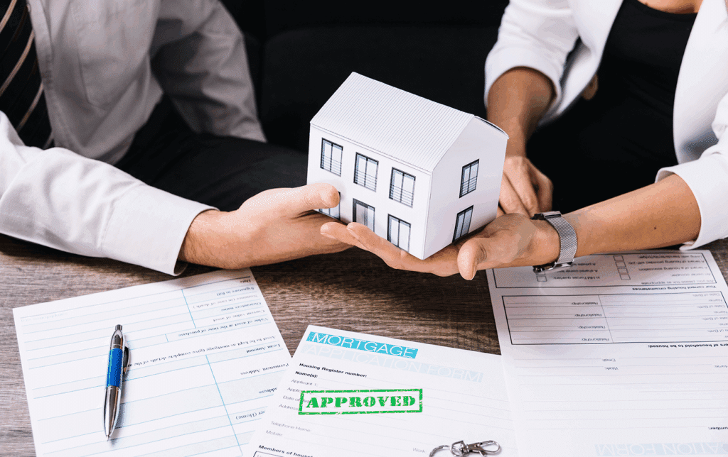 Two men reviewing legal documents for a Florida probate stay in home, holding a small wooden house model on a desk, symbolizing estate planning and property inheritance decisions.